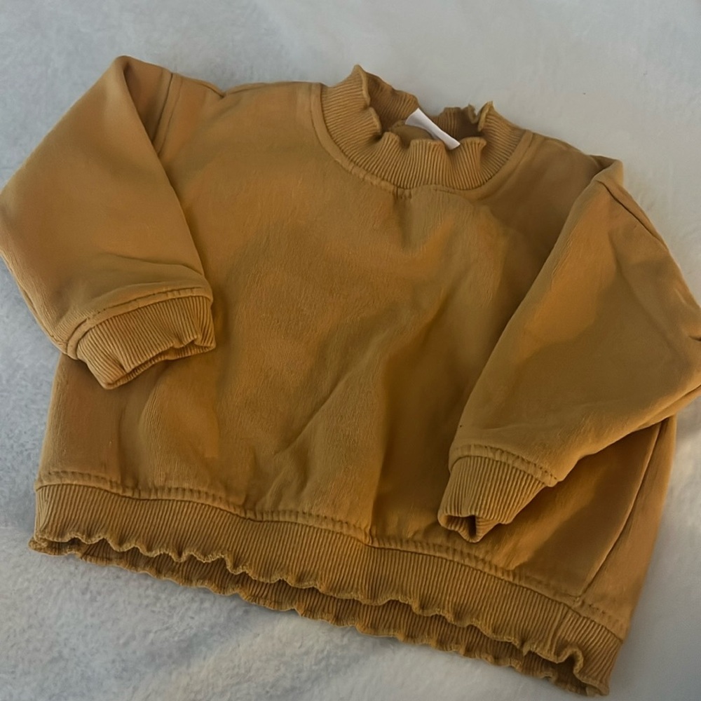 Sweater top color is yellow mustard